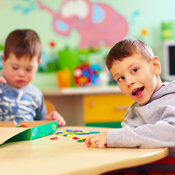 two young boys at a school table